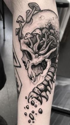 a black and white tattoo with a skull on it