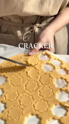 a person cutting into a pastry on top of a white plate with the words cracker cheese over it