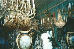 a room filled with lots of different types of chandeliers