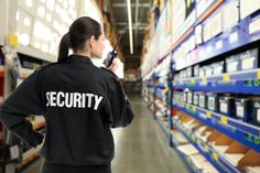 a security guard standing in front of shelves