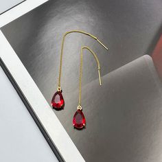 ❤️Deliver gifts on time with our recommended ship-by dates.❤️ - 16 DEC USPS first class mail - 18 DEC USPS Priority mail - 20 DEC USPS Priority mail express These are simple and beautiful red teardrop crystal earrings. Red crystals are framed in bright gold and dangling from long thread.  Matching charm necklace is available for purchase (NOT included with earrings). Measurements: The total length from the top of the hook to bottom - 3.74 inches (95 mm) approximately. Crystals: 12 mm x 8 mm These earrings would be a PERFECT GIFT for you and your family and friends!  Click here to see more Modern Everyday Earrings: https://www.etsy.com/shop/GrigorevaK?ref=seller-platform-mcnav§ion_id=27174357 Thank you for your visit! Dainty Ruby Red Thread Earrings, Red Teardrop Earrings, Statement Ruby Re