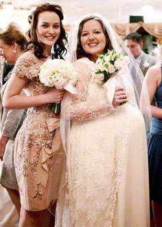 two women in wedding dresses hugging each other