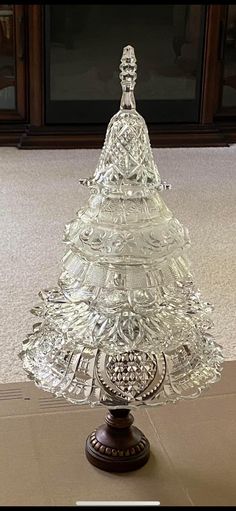 an ornate glass cake stand on the floor