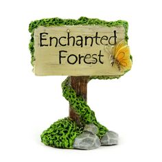 a wooden sign that says enchanted forest with a butterfly on it's back