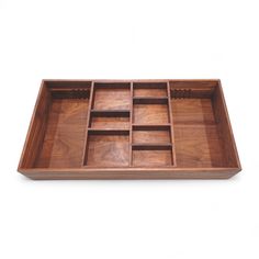 an empty wooden tray with compartments on it