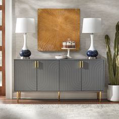 a living room scene with focus on the sideboard and two vases next to it