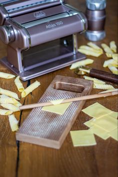 some food is laying out on a wooden table next to a blender and knife