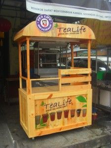 a food cart sitting on the side of a road