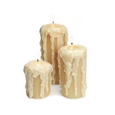 three candles with melting wax on them