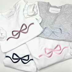 Bows are this seasons biggest trend and we are so in love!  With an oversized embroidered bow across the front, it's perfect to style with a pair of jeans and earrings. This cozy, cute bow embroidered sweatshirt is sure to be a favorite!  Samples shown: White with rose gold thread, Ash with blue thread, White with navy thread and White with pink thread. 8-ounce, 50/50 cotton/poly Double-needle stitching at waistband and cuffs 1x1 rib knit collar, cuffs and waistband with spandex All sales are final due to customization of product. Will ship USPS or UPS unless requested otherwise. Colors may differ slightly from appearance on screen. Find us on Instagram at @shopearthenkind Embroidered Bow, Pink Thread, Bow Ribbon, Embroidered Sweatshirt, Gold Thread, Cute Bow, Gold Threads, Embroidered Sweatshirts, Cute Bows