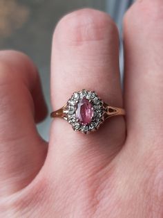 A vintage 9ct gold ruby and diamond ring. The ring is Hallmarked 9ct gold. The 6 x 4mm oval cut ruby is claw set at the centre of the ring. This is surrounded by 12 round brilliant cut diamonds. The total diamond weight is 0.12ct's. Finger size O, but we can make this ring bigger, or smaller. Vintage Ruby Ring With Multi-stone For Collectors, Antique Ruby Ring With Multi-stone, Antique Multi-stone Ruby Ring In Gold, Antique Ruby Ring As Gift, Hallmarked, Vintage 14k Gold Multi-stone Ruby Ring, Oval Cut, Round Brilliant Cut Diamond, Rings Statement, Ruby