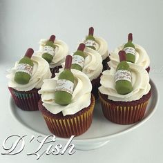 several cupcakes with white frosting and green toppings on a platter