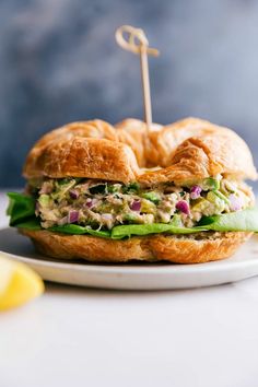 a chicken salad sandwich on a croissant bun