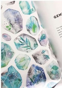 an open book with watercolor leaves on it