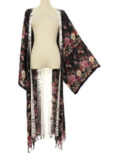 Elevate your style with this stunning plus size boho hippie floral kimono tassel long jacket, made with lightweight spun rayon fabric. This long jacket features a beautiful floral pattern and fringed accents that add a touch of bohemian flair to any outfit. The relaxed fit and kimono sleeves provide both comfort and breathability, making it perfect for casual wear, beach outings, parties, or festivals. This bohemian-style jacket comes with a matching belt and is available in plus one sizes 2X 3X Long Tasseled Kimono For Spring, Bohemian Floral Print Winter Cardigan, Spring Kimono With Tassels And Long Sleeves, Spring Long Sleeve Kimono With Tassels, Long Sleeve Kimono With Tassels For Spring, Spring Fringed Long Sleeve Kimono, Spring Fringe Long Sleeve Kimono, Spring Long Sleeve Fringed Kimono, Bohemian Fringe Kimono For Fall