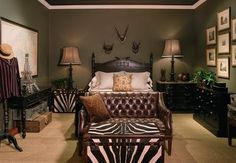 a bedroom with zebra print furniture and pictures on the wall