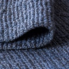 a close up view of a blue knitted blanket