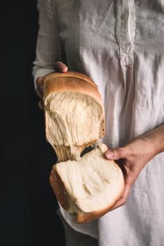 a person holding a loaf of bread in their hands