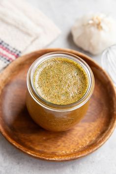 a wooden plate topped with a jar of mustard