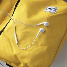 an earphone is plugged in to a yellow bag