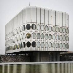 an unusual building with circular windows on the side