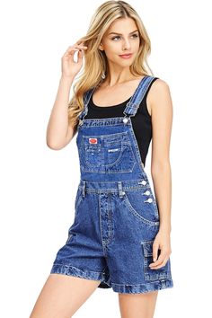 a woman in overalls posing for the camera