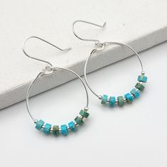 Add a pop of color to your boho look with our silver hoop earrings featuring turquoise jasper stones. These playful and unique earrings will bring a touch of whimsy to any outfit. .925 Sterling Silver Measure approximately 1.125" in diameter Earrings Hang 1.75" from top of ear wire Turquoise Jasper Gemstones Polished to a high shine Sent in a Gift Box with Polishing Cloth Handmade in Montana Turquoise Dangle Hoop Earrings Nickel Free, Nickel-free Turquoise Dangle Hoop Earrings, Turquoise Natural Stone Hoop Earrings As Gift, Turquoise Hoop Earrings With Natural Stones As Gift, Handmade Turquoise Sterling Silver Hoop Earrings, Turquoise Sterling Silver Nickel-free Hoop Earrings, Nickel-free Turquoise Small Hoop Jewelry, Small Turquoise Nickel-free Hoop Earrings, Turquoise Nickel-free Small Hoop Earrings