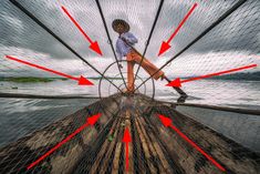 a man riding on top of a wooden boat