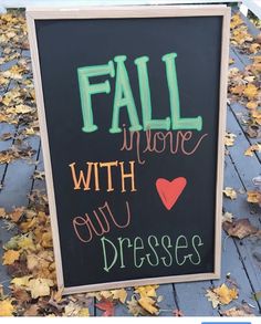 a sign that says fall in love with our dresses