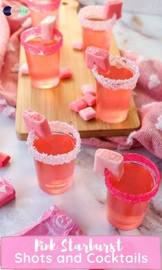 pink starburst shots and cocktails on a wooden tray with marshmallows