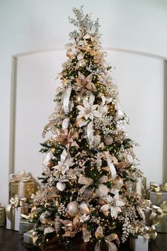 a decorated christmas tree with gold and silver decorations