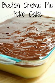 a brownie in a glass baking dish with chocolate frosting on top and the words boston creme pie poke cake above it