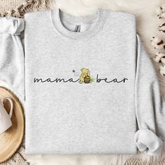 Introducing our newest Mama Pooh Bear Sweatshirt -- Crafted with premium cotton blend, this cozy sweatshirt not only offers warmth but also makes a great additon to any moms wardrobe. The collar is ribbed knit, so it retains its shape even after washing. There are no itchy side seams on these sweatershirts. Nice for chilly evenings and colder days, this sweatshirt will be a staple all season. For oversized style/look - please size up. See size chart for reference. Due to monitor settings and lig Crew Neck Cotton Hoodie For Mother's Day, Crew Neck Cotton Hoodie, Cotton Long Sleeve Sweatshirt With Name Print, Cotton Long Sleeve Sweatshirt For Gift, Cute Crew Neck Sweatshirt For Mother's Day, Cute Fleece Sweatshirt With Letter Print, Cotton Sweatshirt With Name Print, Crew Neck Cotton Hoodie With Name Print, Cozy Sweatshirt As A Gift