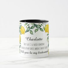 a coffee mug with the words charlotte written on it and lemons in green leaves