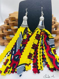 These bold and beautiful earrings are made from African print fabric and adorned with gold metal charms. Ear wires are 14k gold plated or sterling silver. Tribe Up! Pride, Culture and Identity... Represent Yours! Byblackbydesign Adjustable Artistic Yellow Earrings, Artistic Adjustable Yellow Earrings, Winter Face, African Earrings, Fabric Earrings, Ankara Fabric, African Print Fabric, Metal Charm, African Fabric