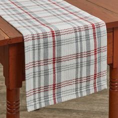 a plaid table runner on top of a wooden table