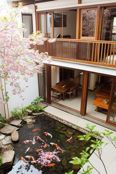 a small pond in the middle of a patio with koi fish swimming around it