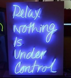 a neon sign that says relax nothing is under control