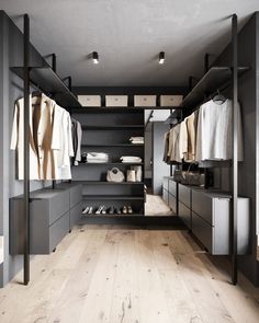 a walk in closet with wooden floors and shelves