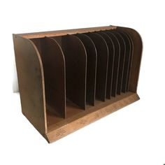 a set of six metal bookends sitting on top of a wooden shelf next to a white wall