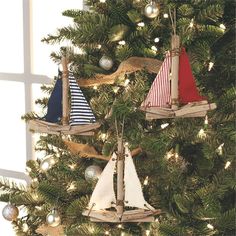 a christmas tree decorated with sailboats and ornaments