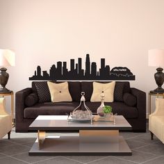 a living room with couches, chairs and a coffee table in front of a city skyline wall decal