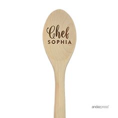 a wooden spoon with the words paul's chili on it and a brown lettering