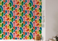 a colorful wallpaper with lots of ghost heads on it