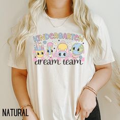 Kindergarten Teacher Shirt, Kindergarten Dream Team Shirt, Kindergarten Team T-shirt, Back To School Shirts, Kinder Crew, Retro Teacher Tee If you are looking for soft, well designed, and comfy t -shirts, you have come to the right place! We strive to provide beautiful shirts for all occasions as well as a great customer experience. If you have any questions about our shirts, please feel free to shoot us a message anytime. We try our best to message everyone back within 24 hours. Product Details Cute Cotton Shirt With Sublimation Print, Cute Crew Neck Shirt With Sublimation Print, Cotton T-shirt With Sublimation Print For School, Sublimation Print Crew Neck Shirt For School, Crew Neck Cartoon Print Tops For School, Crew Neck Tops With Cartoon Print, School Tops With Cartoon Print And Crew Neck, School Crew Neck Tops With Cartoon Print, White Relaxed Fit T-shirt For School