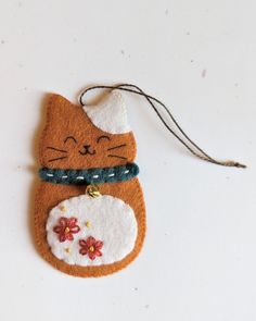 a cat ornament hanging from a string