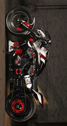 an aerial view of a motorcycle parked on the side of a building with red rims