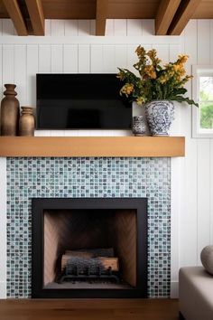 a living room with a fireplace and tv above it