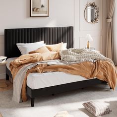 a bedroom with a bed, pillows and blankets on the top of it's headboard