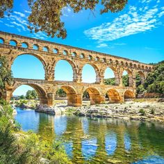 an old stone bridge over a river